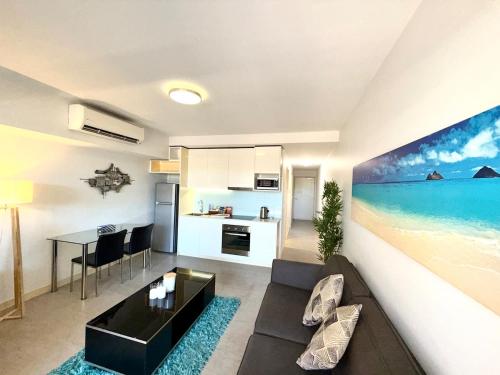 a living room with a couch and a table at The Padbury Suites-Premium City Apartment in Karratha