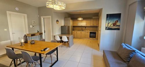 a living room and kitchen with a table and chairs at ELINOR on the beach in Flogita