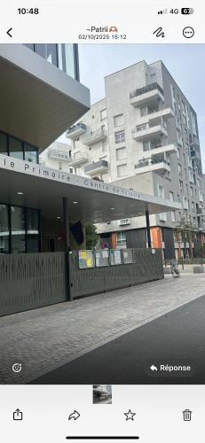 a large building in front of a building at Chambre privée Sdb kitchenette proche de Paris in Saint-Ouen