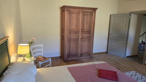 a bedroom with a bed and a wooden cabinet at Castello di Vecchienna in Monterotondo
