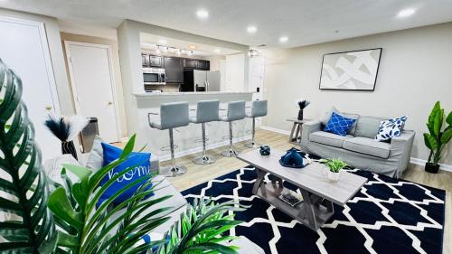 a living room with a couch and a table at Lavish Escape in Charlotte