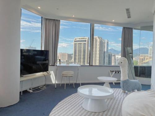 a living room with a view of a city at 苓旅松山館 Lininn Tapei Arena in Taipei