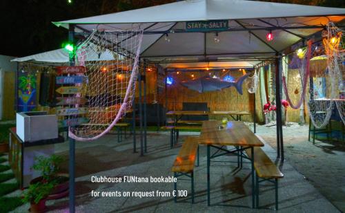 a tent with a table and a swing at Mobile Fontana Oasis in Castelnuovo del Garda