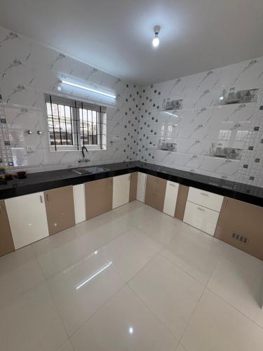 a room with a kitchen with a counter and a sink at Iris Groove Ooty by Avkanz in Ooty