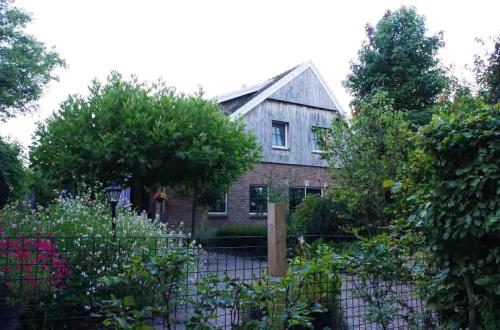 an old house with a garden in front of it at B&B Erve Möskert in Geesteren