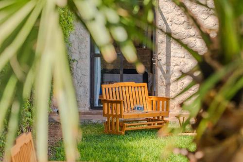two wooden chairs sitting in the yard of a house at Villa La Rose Bleue - Résidence Hôtelière avec Piscine - Essaouira in Essaouira