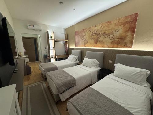 a hotel room with two beds and a painting on the wall at Brianza Home in Giussano