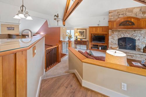 an open kitchen and living room with a fireplace at The Forest Neighborhood by Keystone Resort in Keystone