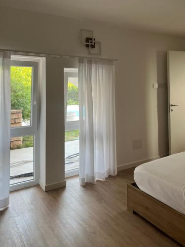 a bedroom with a bed and sliding glass doors at Casa Luca in Garda