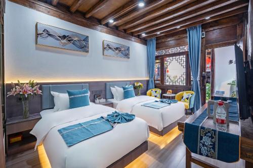 Una cama o camas en una habitación de Frida's Inn 晴雪阁美宿客栈