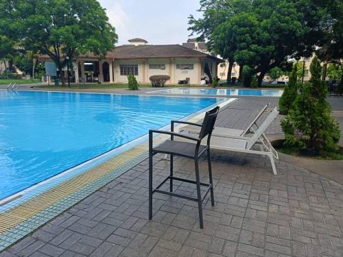 a chair sitting in front of a swimming pool at Vista Home in Kajang