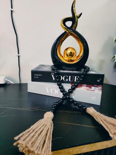a necklace on top of books on a table at Staycation with Ryn in Ruaka