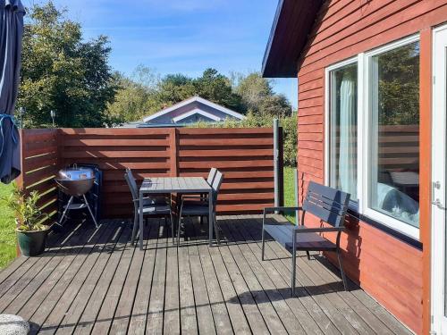 a patio with a table and chairs and a fence at 6 person holiday home in Nibe in Nibe