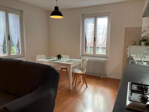 a kitchen with a table and chairs in a room at Vicino Zoncolan+Netflix e Wifi in Treppo Carnico
