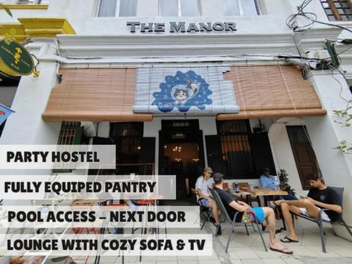 a group of people sitting in front of a building at The Manor by Mingle - Poolside Access Next Door in Kuala Lumpur