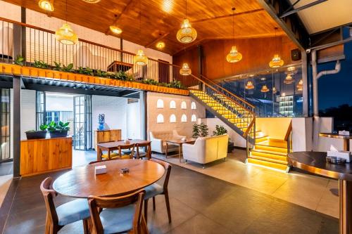 a restaurant with a table and chairs and a staircase at Hotel Sara Sadan in Kathmandu