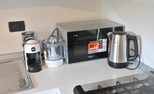 a counter top with a microwave and appliances on it at Casa Sant Anna in Pordenone