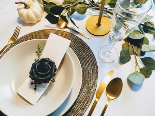 a table with a white plate with a black flower on it at Casa Fuerte Playa in La Herradura