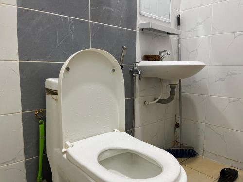 a bathroom with a toilet and a sink at 3A HOMESTAY USTAZ Krai in Kuala Kerai