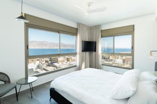 a bedroom with a bed and a view of the ocean at Villa Dekel - By Harim in Eilat