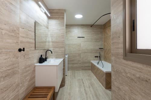 a bathroom with a sink and a shower and a tub at Villa Dekel - By Harim in Eilat