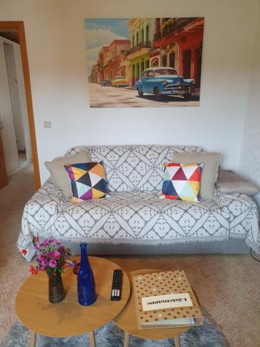 a living room with a couch and a table at Wünschel Stube in Gossersweiler-Stein