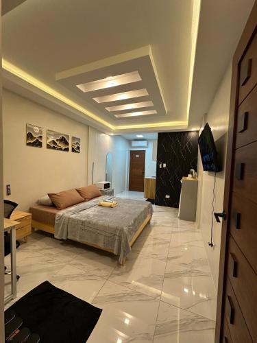 a bedroom with a bed and a television in it at Casa Leveria Unit 6 with Balcony, Inquire Parking Availability in Imus