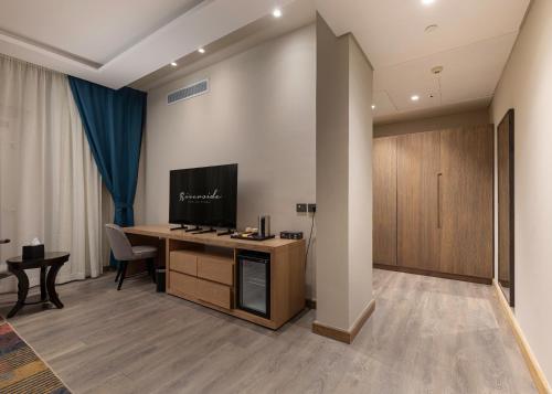 a hotel room with a desk with a television on it at Riverside Hotel in Cairo