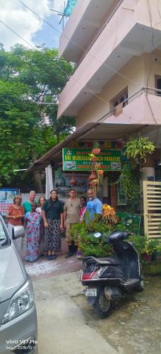 a group of people standing in front of a store at Sri Murugan Beach Paradise Hotel in Mahabalipuram