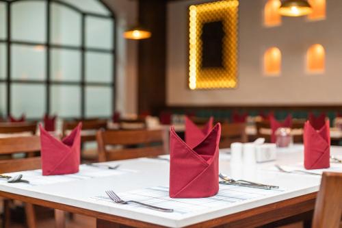 a table in a restaurant with red napkins at Hotel Sara Sadan in Kathmandu