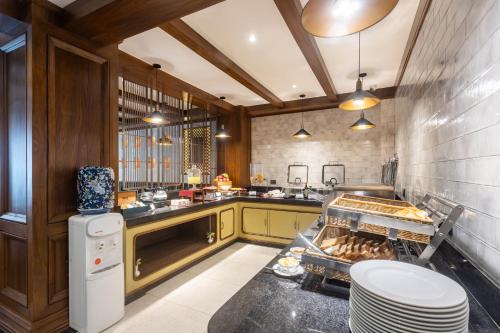 a kitchen with a counter with a grill in it at Hotel Sara Sadan in Kathmandu