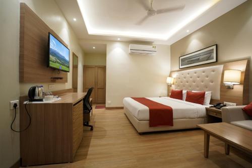 a hotel room with a bed and a television at Kalinga Hotel in Jodhpur