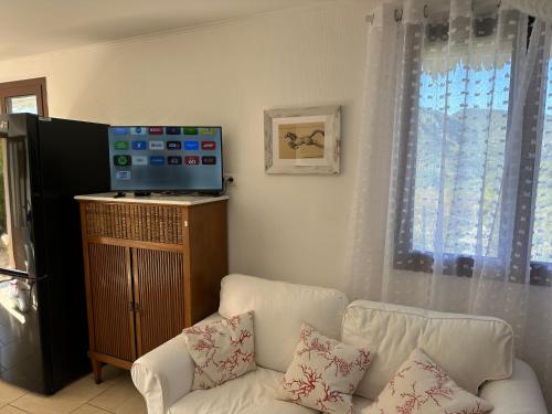 a living room with a white couch and a window at Charming Mountain Escape in Sospel, Perfect for Nature Lovers in Sospel