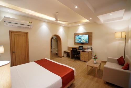 a hotel room with a bed and a desk at Kalinga Hotel in Jodhpur