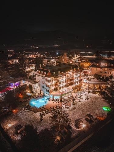 an aerial view of a building at night at Majestic - Unique Spa Resort in Brunico