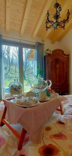 a table with plates and dishes on it in a room at I Custodi del Bosco in Gorizia