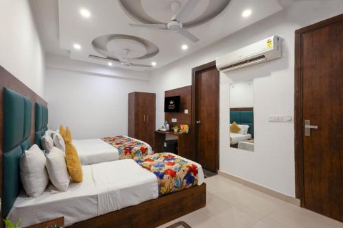 a bedroom with two beds and a bathroom at Hotel TEJ Aerocity-FREE Airport Drop in New Delhi
