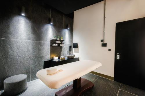 a bathroom with a table and a fireplace at Tiny Vanguard- Cosy flat with free luxe wellness in Prague