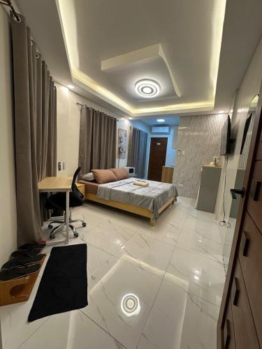 a bedroom with a bed and a desk in it at Casa Leveria Unit 9 with Balcony, Inquire Parking Availability in Imus