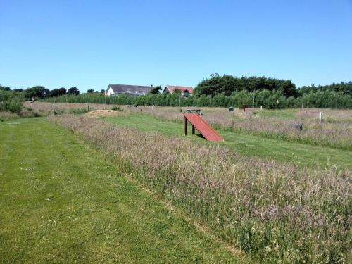 a red object in the middle of a field at 4 person holiday home in Fanø-By Traum in Fanø