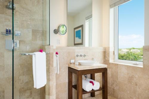 a bathroom with a sink and a window at West Bay Club in Grace Bay