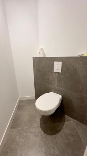 a bathroom with a white toilet in a room at Le ONZE in Longwy
