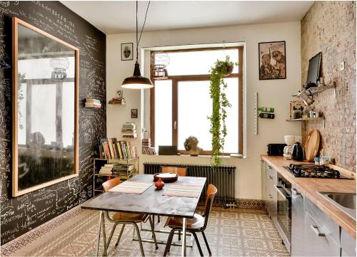 a kitchen with a table and chairs and a window at B'Kanal in Brussels