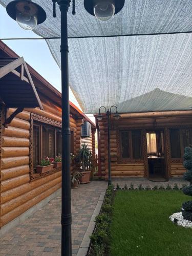 a wooden house with a pergola in the yard at Hotel 365 in Zvartnots International Airport