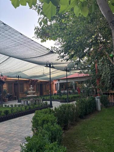 a building with a canopy over a courtyard with a fountain at Hotel 365 in Zvartnots International Airport
