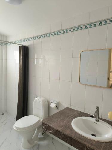 a bathroom with a toilet and a sink at Spacious 2-bedroom villa near beach in Ban Krut