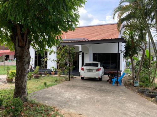 a white car parked in front of a house at Spacious 2-bedroom villa near beach in Ban Krut