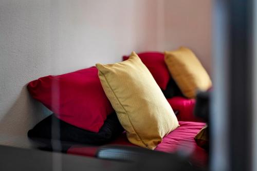 a couch with pillows on it in a room at STR8BS8 2-Bedroom Penthouse, Clifton, Parking, Garden & City Views in Bristol