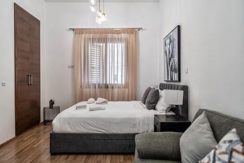 a bedroom with a large bed and a couch at Cozy house city center in Limassol in Limassol