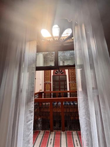 a window with curtains in front of a building at Riad Ayoub Fes in Fès